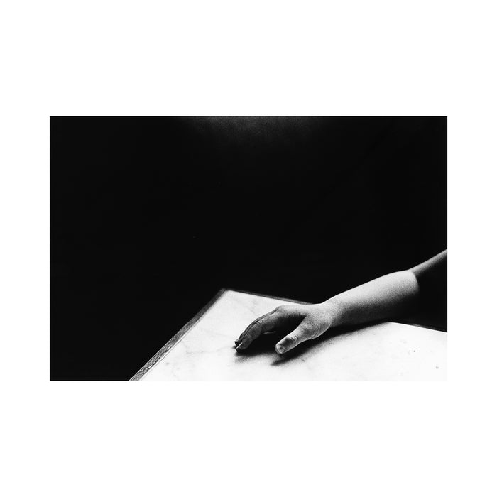 Untitled (hand and marble table)